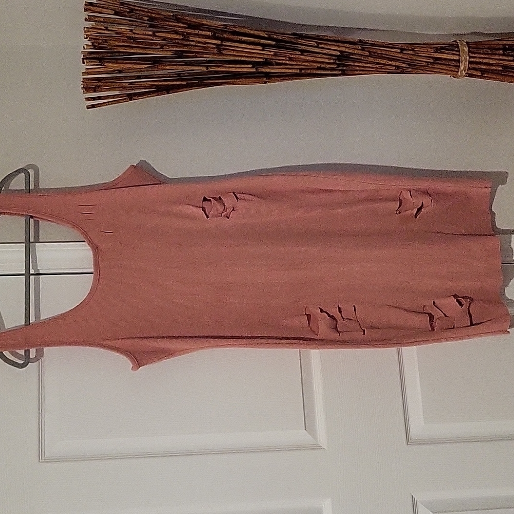 Pinkish peach colored dress with cutouts.